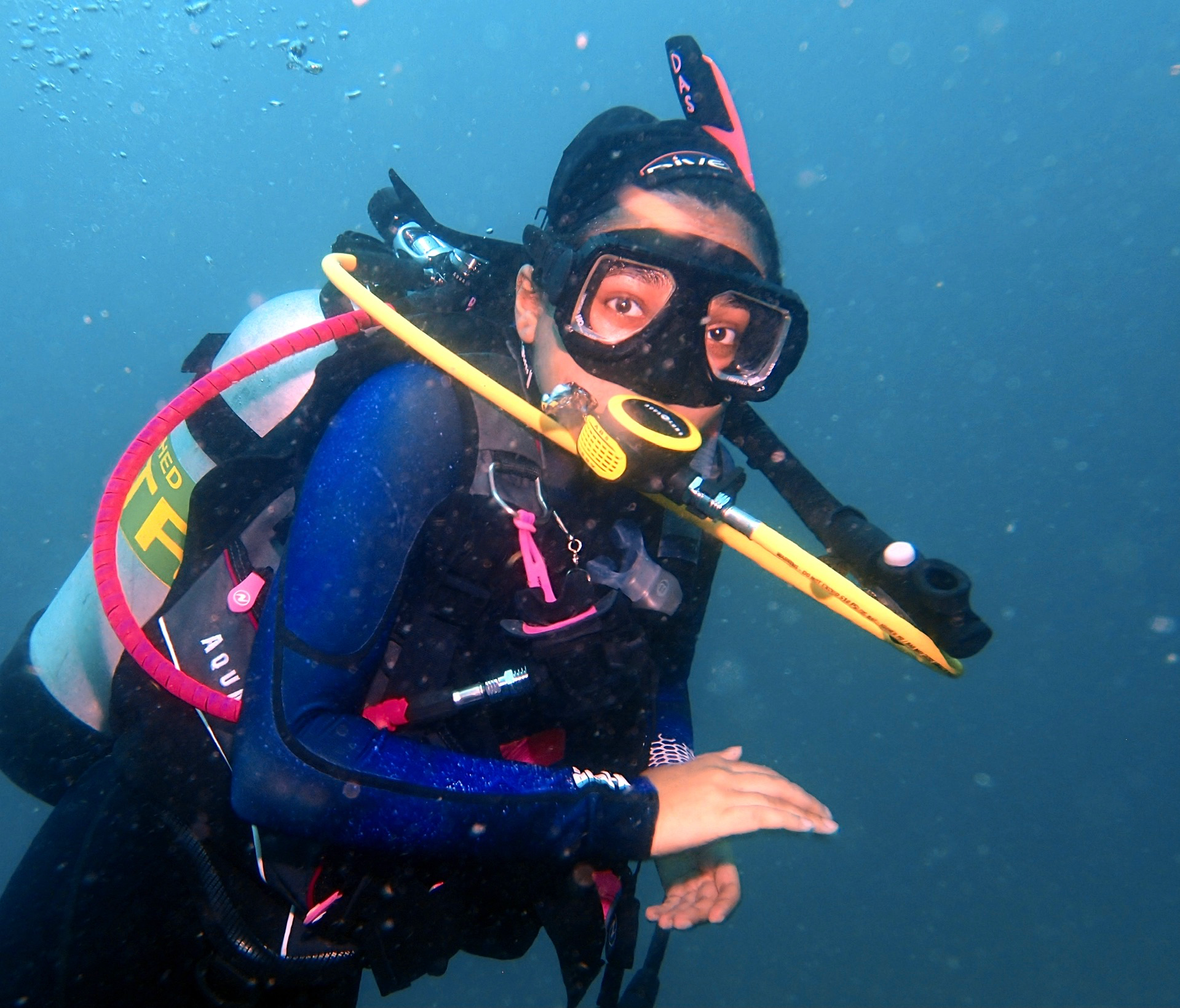 I am scuba diving over a coral reef